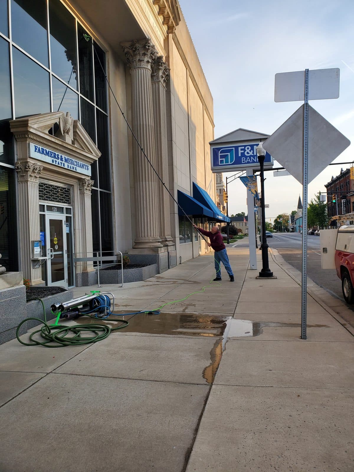 Aaron Pittsenbarger cleaning a downtown Urbana storefront