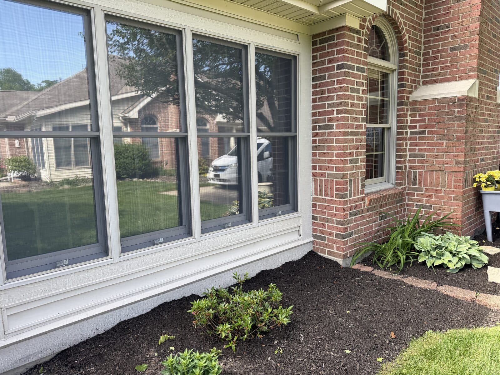Crystal-clear residential windows on a Champaign County brick home after a Clean As A Whistle cleaning